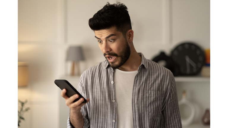 Man holding smartphone read unpleasant sms feels stressed
