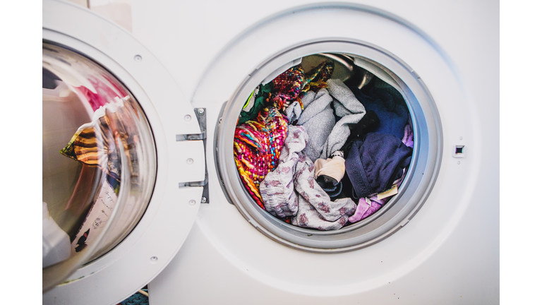 laundry day.Washing machine full of colorful clothes