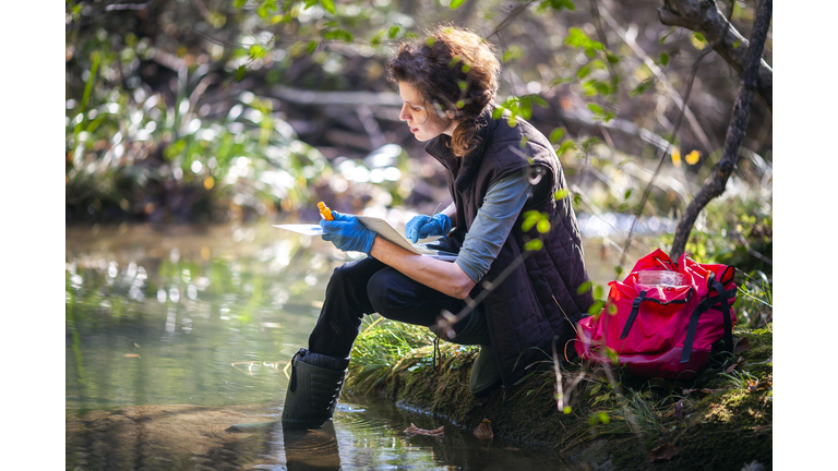 Female Biology Researcher Working in Nature