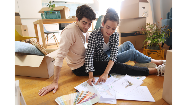 A young couple looking at plans of their new home