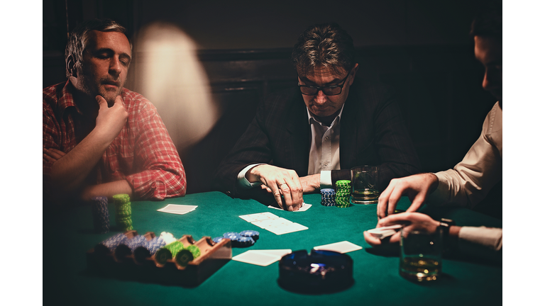 Men playing poker late by night