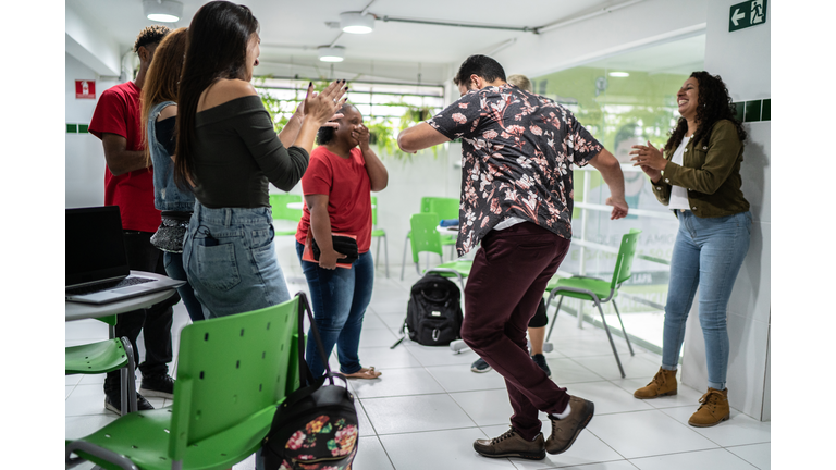 Group of friends dancing at school's patio