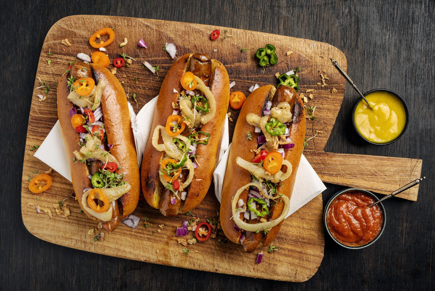 Artisan Hot Dogs in Brioche Rolls with pickles, onion and relishes.
