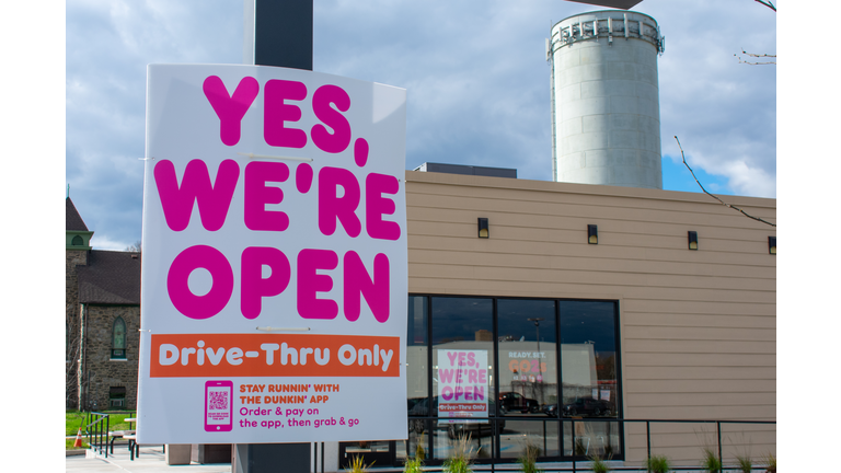 ELKINS PARK, PENNSYLVANIA - APRIL 1, 2020: A Dunkin Donuts Sign Saying The Drive-Thru Remains Open in Repsonse to COVID-19