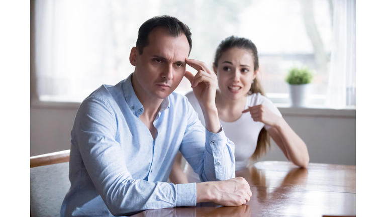 Depressed man turn back ignoring angry screaming woman