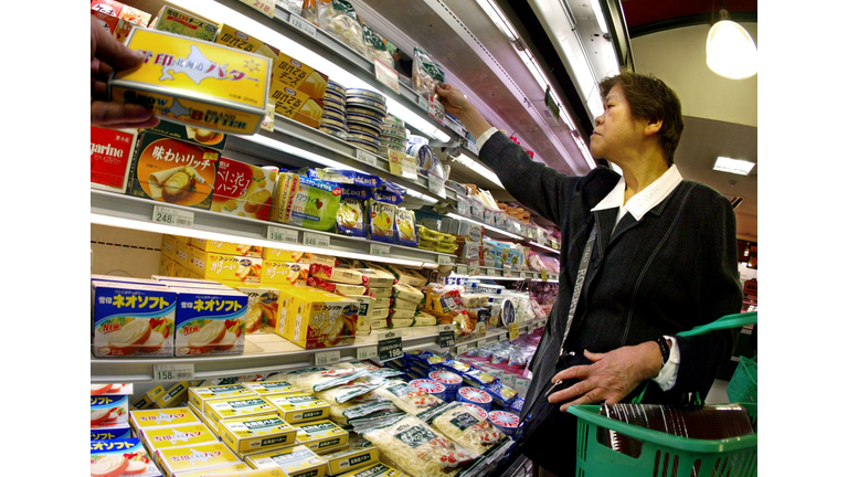 A Japanese customer checks dairy products includin