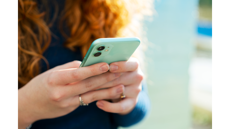 Close up or woman using smart phone