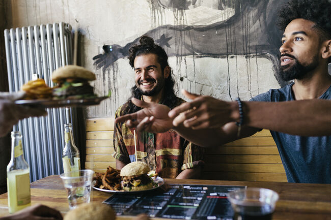 Waiter Handing Burger To Customer