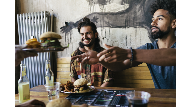 Waiter Handing Burger To Customer