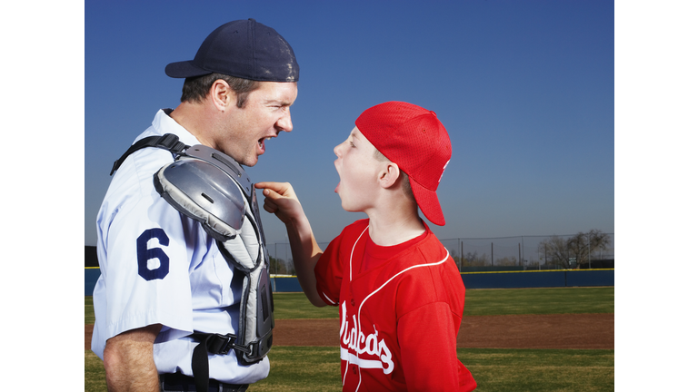 Young Baseball Player Arguing with Umpire