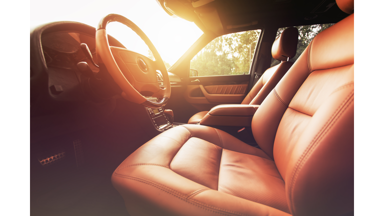 Premium car interior, brown leather at sunset