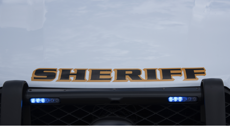 Sheriff vehicle with blue grill lights