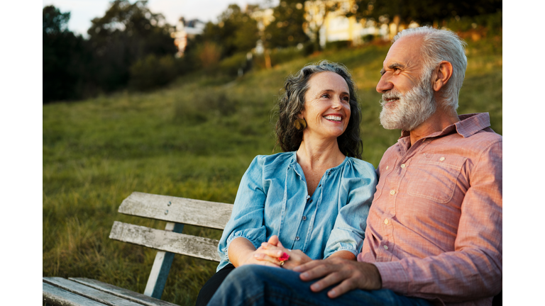 Man and woman on bench, smiling