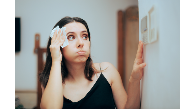 Woman Felling Hot During Summer Setting Her Thermostat