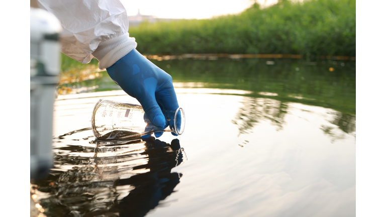 Environment engineer Collect samples of wastewater from industrial canals in test tube, Close up hand with glove Collect samples of wastewater from industrial canals in test tube. mobile water laboratory check