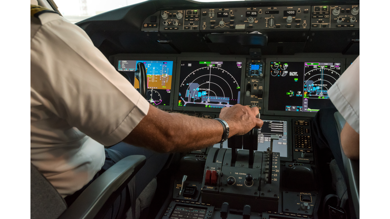 Modern commercial jet aircraft cockpit and pilots