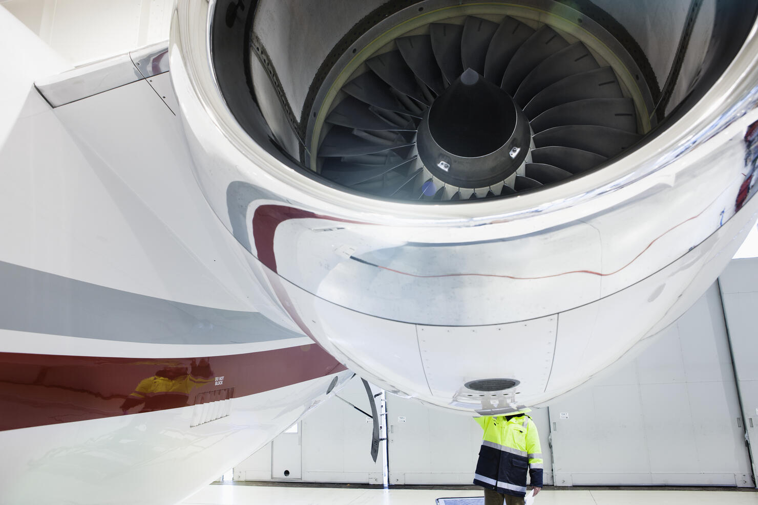 Aviation mechanic making repairs to jet plane