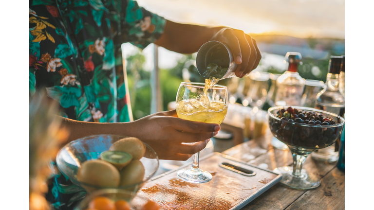Bartender serving a fruit cocktail