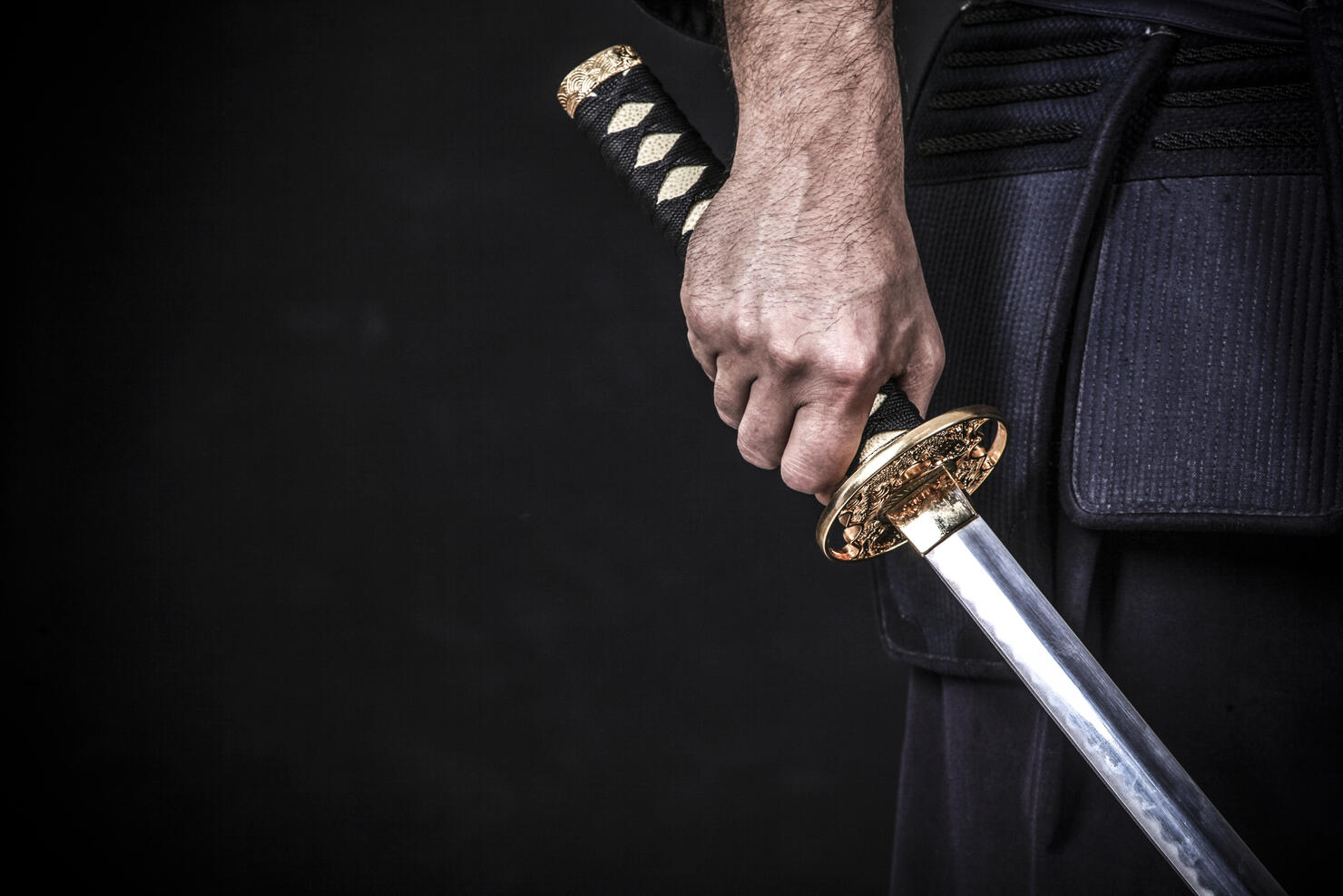 Asian man holding a katana