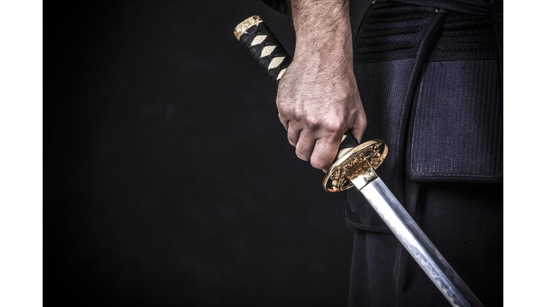 Asian man holding a katana