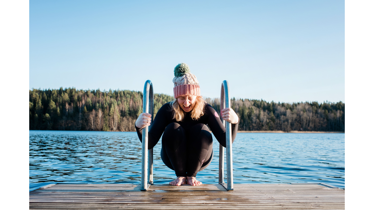 woman looking nervous about cold water ice swimming in Sweden