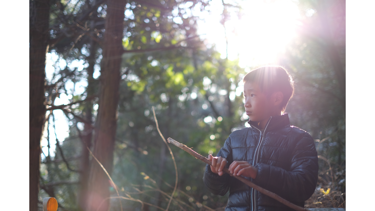 Boy playing with a stick