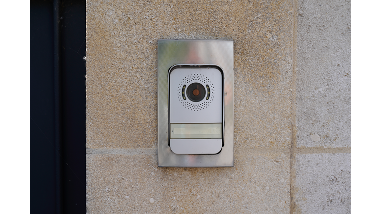 Ring surveillance video on modern house with contemporary doorbell near door