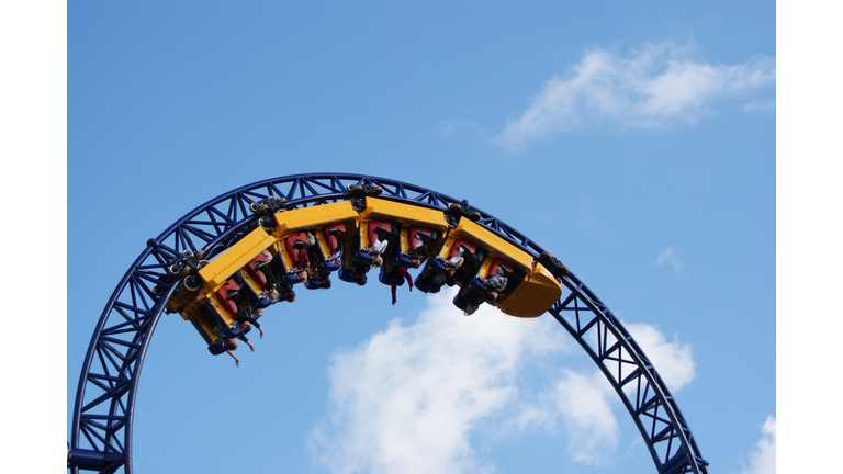 People hanging upside down on the roller coaster track