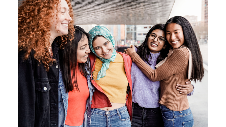 Multiethnic female friends having fun outdoor - People from diverse cultures and races - Focus on Muslim girl face