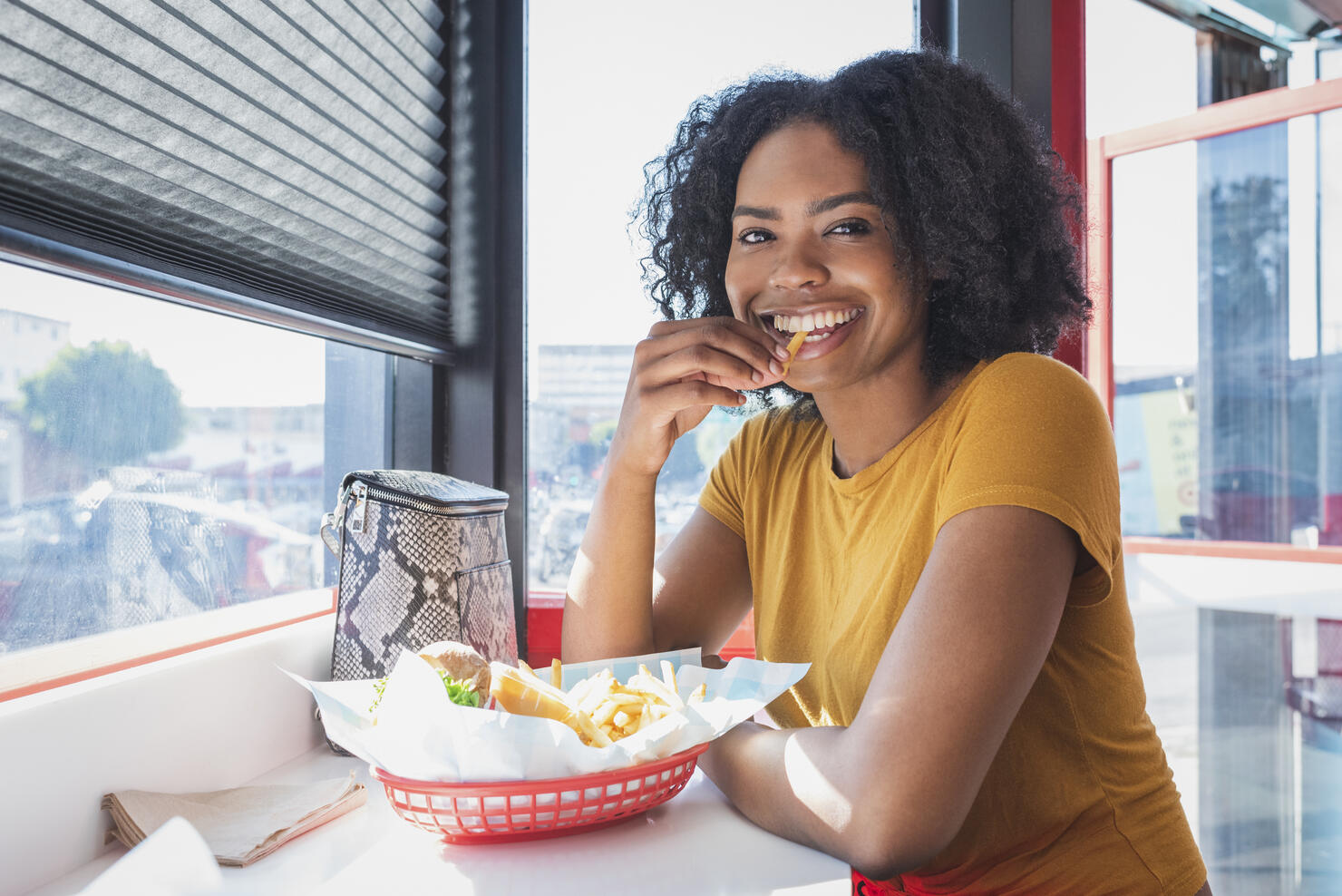 Young woman eating in diner