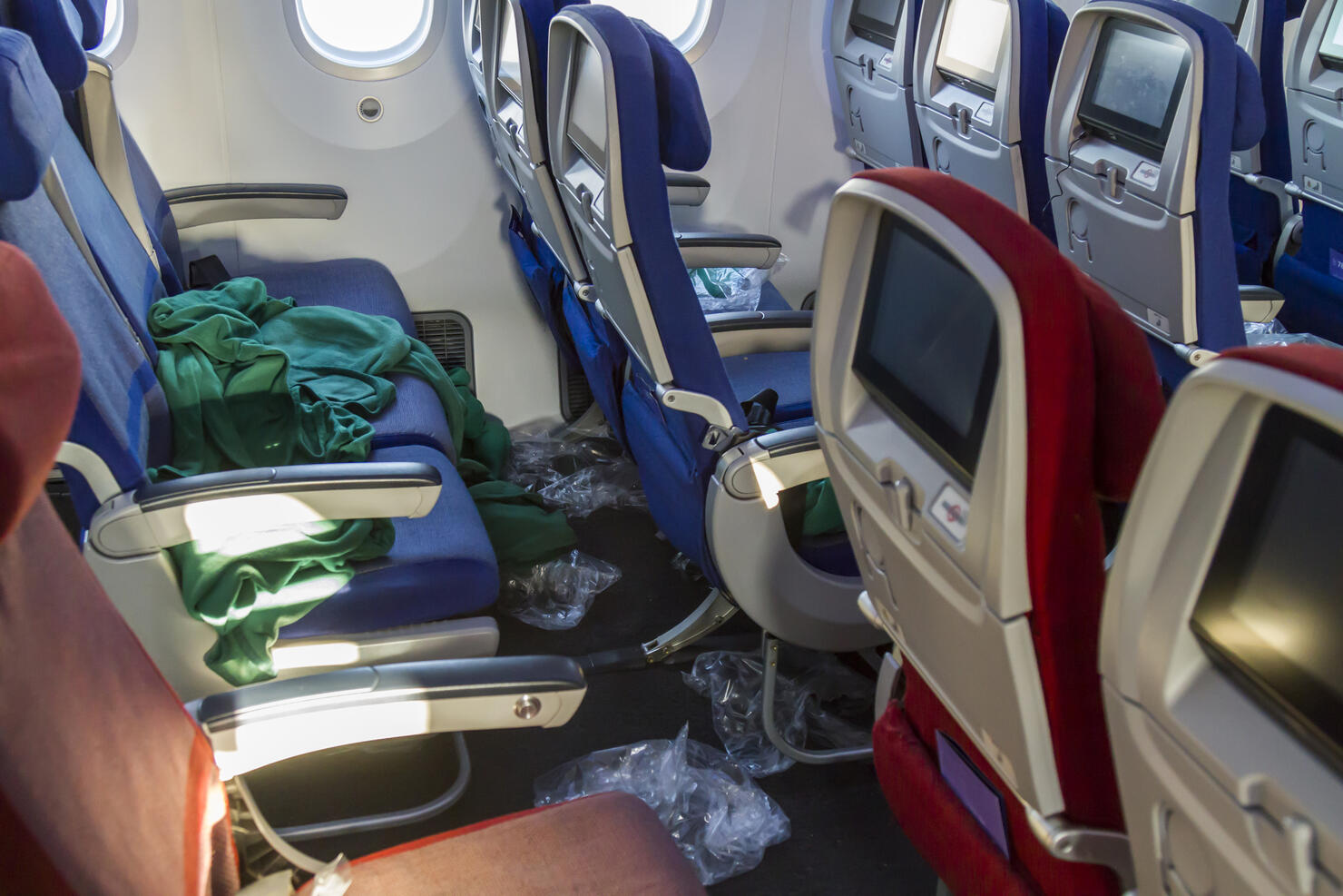 Messy inside view of commercial aircraft cabin airplane economic area.