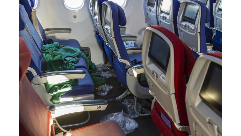 Messy inside view of commercial aircraft cabin airplane economic area.