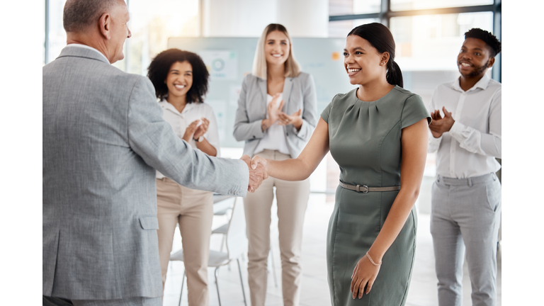 Happy handshake, by man and woman in office, for promotion in business, team gives applause. Meeting with diversity in people celebrate worker's progress to new role in corporate marketing job.