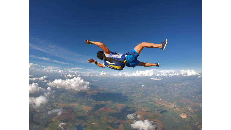 Skydiver jumping with shorts and t-shirt