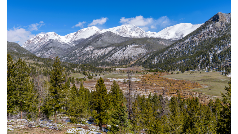 Spring at Rocky Mountain National Park - A panoramic view of Rocky Mountain National Park on a sunny morning after a Spring snowstorm, with snow-capped Mummy Range towering in background, Colorado, USA.