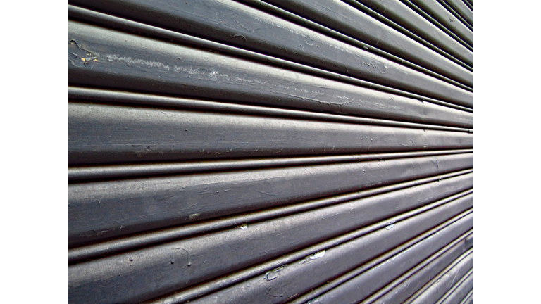 Weathered roller shutter in black metal with copy space  in Paris