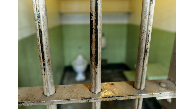 The worn bars in the cell block are seen