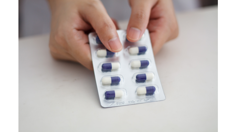 Close up of female doctor hands holding pills