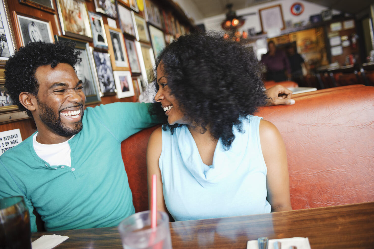 Smiling couple sitting in diner booth