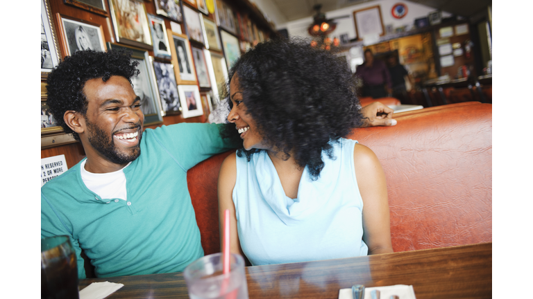 Smiling couple sitting in diner booth