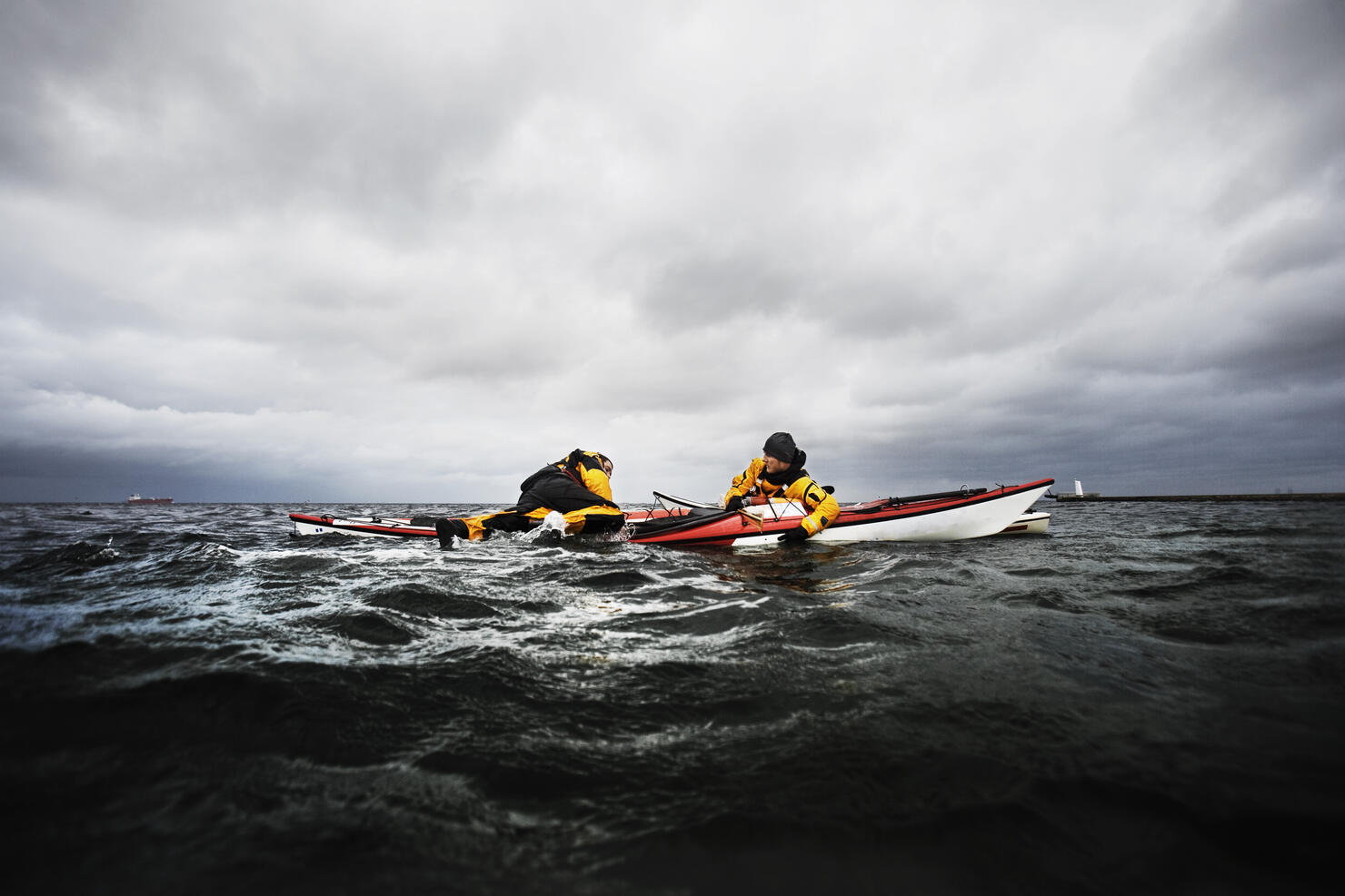 Freinds in kayak helping each other