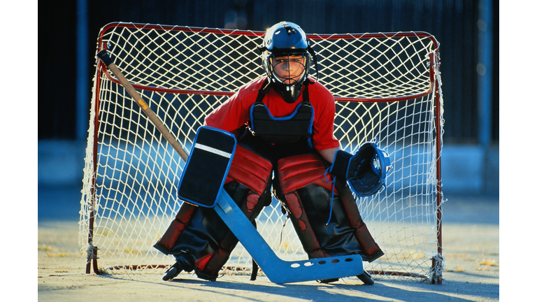 Street hockey goalie(10-12) in front of goal