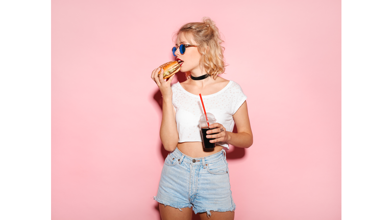 Pretty girl biting a burger