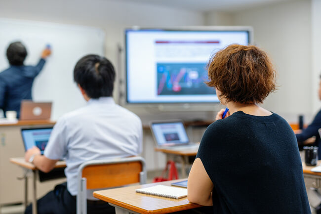 Mid adult woman in a continuing education class at a community college or university