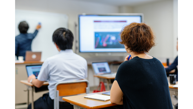 Mid adult woman in a continuing education class at a community college or university