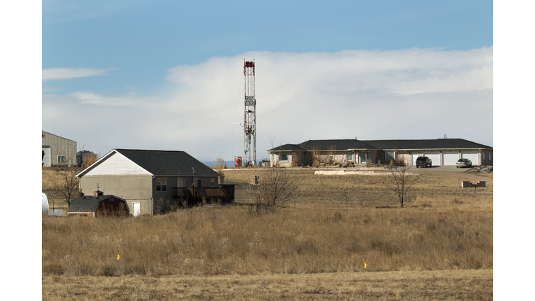Homes and oil fracking drill rig Lochbuie Colorado