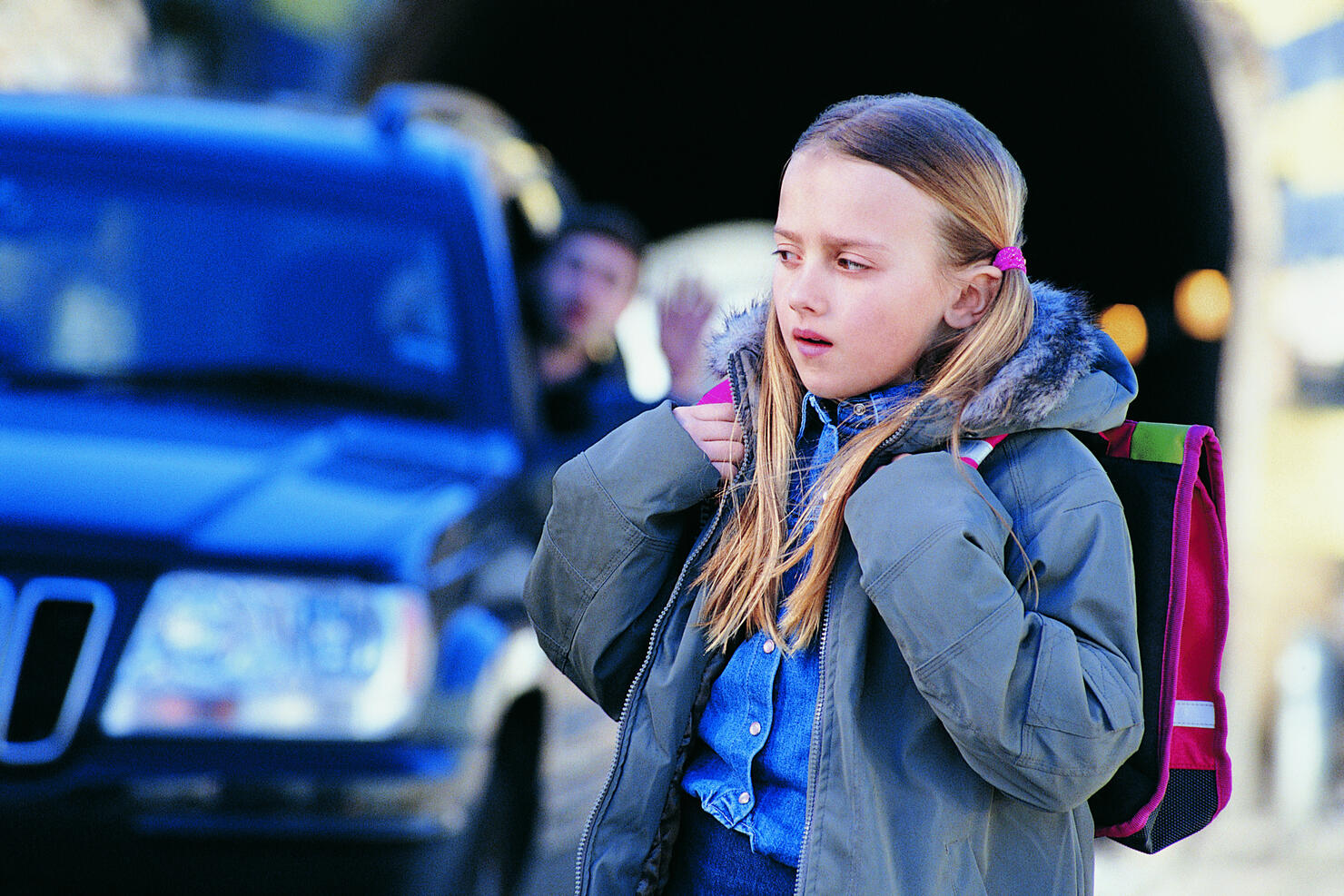 Man in a Car Waving to an Apprehensive Girl Standing in a City Street