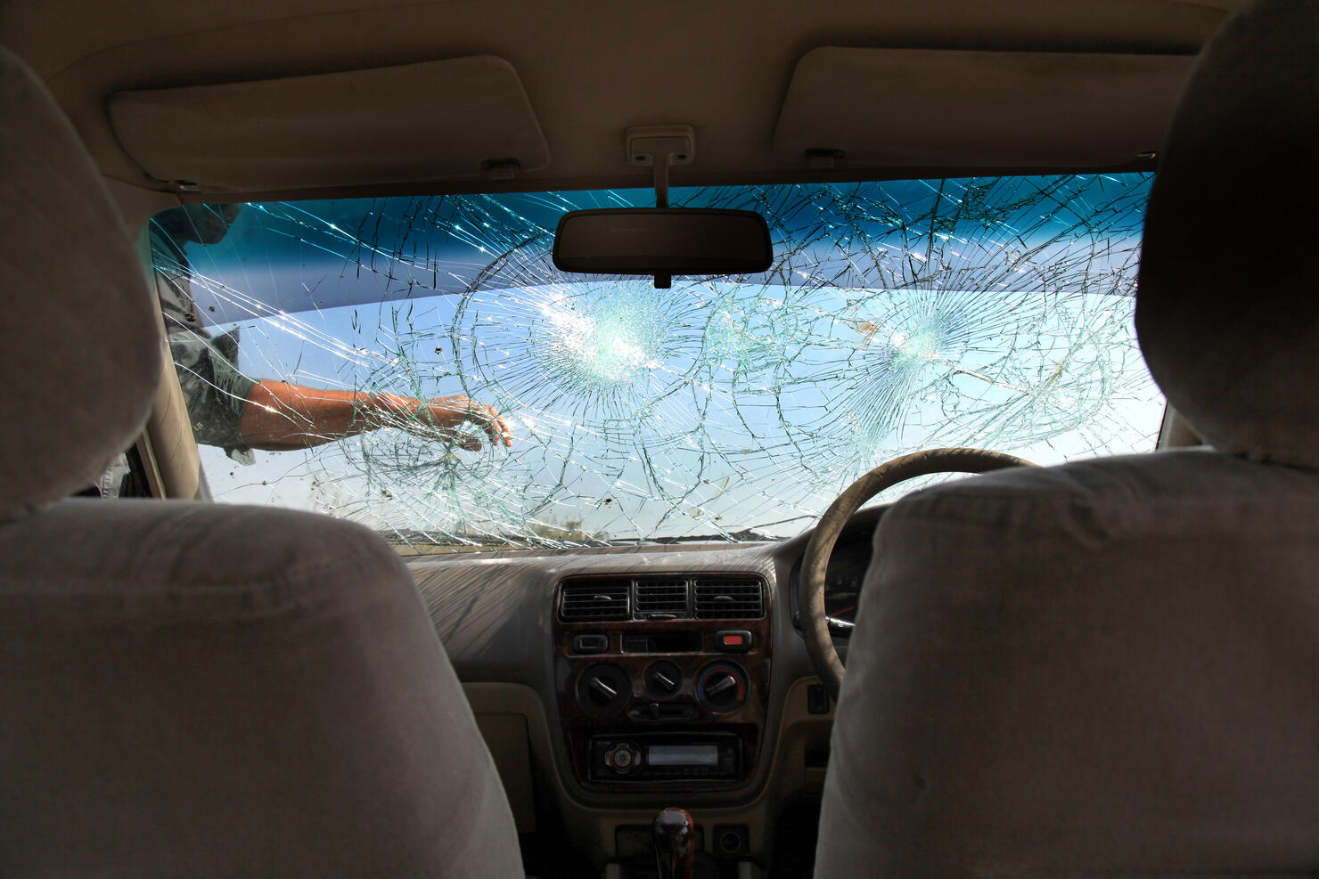 Inside of car with the broken windshield during road accident