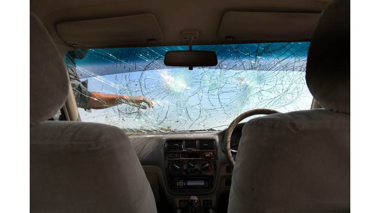 Inside of car with the broken windshield during road accident