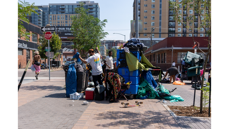 Homeless of Denver live in tents on a street of city.